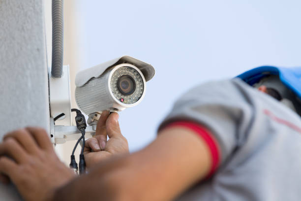 Security camera service man working. Security camera service man working.