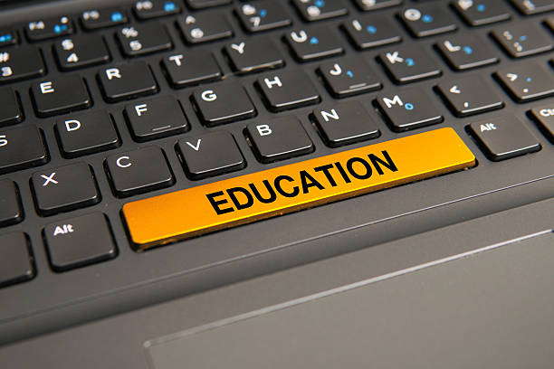 Close up of a computer keyboard with a yellow education key, representing learning, knowledge acquisition, online education, academic development, and lifelong learning concepts.