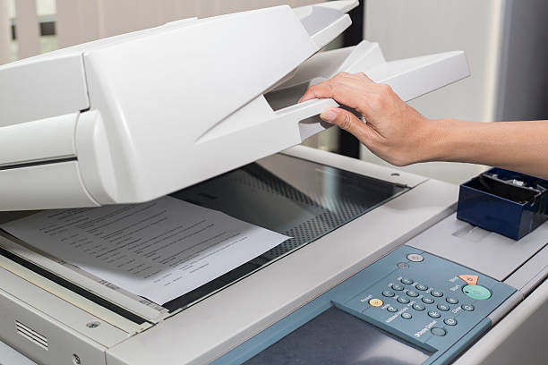 woman opening a photocopier woman opening a photocopier