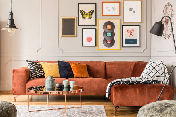 Eclectic living room interior with comfortable velvet corner sofa with pillows Eclectic living room interior with comfortable velvet corner sofa with pillows