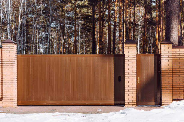 Entrance Sliding Gate with Metal and brick Fence. Modern Automatic Gate to Private house
